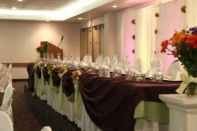 a long table with wine glasses on it in a room at St. Albert Inn & Suites in St. Albert