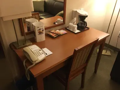 a telephone sitting on a desk in a hotel room at St. Albert Inn & Suites in St. Albert