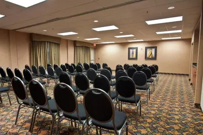 a room with rows of chairs in a conference room at Days Inn & Suites by Wyndham Strathmore in Strathmore