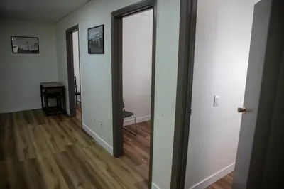 an empty room with white walls and wooden floors at Ramada by Wyndham Dawson Creek in Dawson Creek
