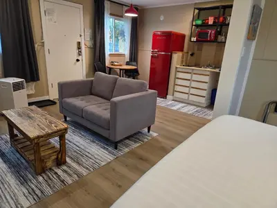 a living room with a couch and a table at Lido Motel in Radium Hot Springs