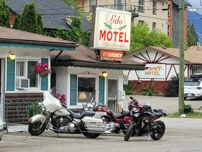 two motorcycles parked in a parking lot in front of a motel at Lido Motel in Radium Hot Springs