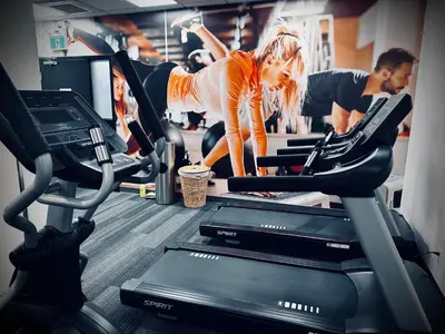 a woman on a treadmill in a gym at Mountain View Resort and Suites at Fairmont Hot Springs in Fairmont Hot Springs