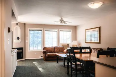 a living room with a table and a couch at Mountain View Resort and Suites at Fairmont Hot Springs in Fairmont Hot Springs