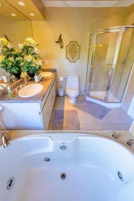 a bathroom with a tub and a toilet and a shower at Crystal's View Bed & Breakfast in North Vancouver