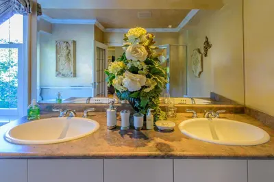 two sinks in a bathroom with flowers on the counter at Crystal's View Bed & Breakfast in North Vancouver
