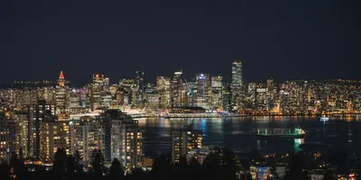a night view of a large city with the water at Crystal's View Bed & Breakfast in North Vancouver
