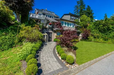 a house with a walkway in front of a yard at Crystal's View Bed & Breakfast in North Vancouver