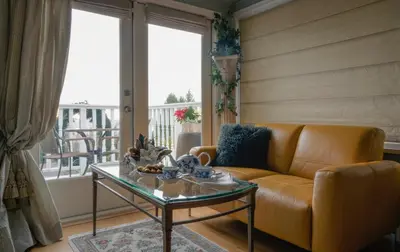 a living room with a couch and a glass table at Crystal's View Bed & Breakfast in North Vancouver