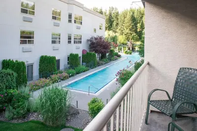 a view of a pool from a balcony of a building at Hilltop Inn - Salmon Arm in Salmon Arm