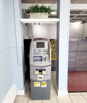 a atm machine in a room with a wall at Canadian Motor Inn in Grande Prairie