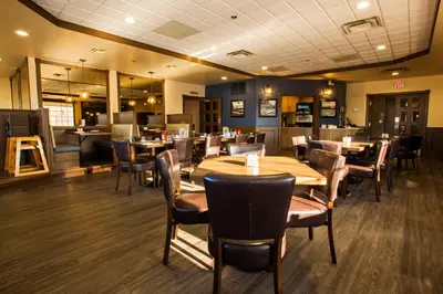 a dining room with wooden tables and chairs at Tower Inn & Suites in Quesnel