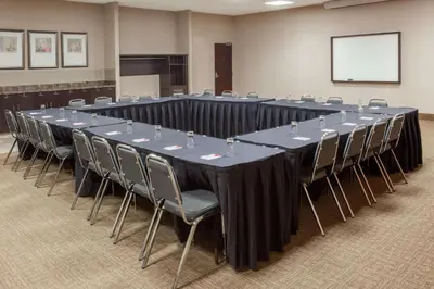 a large conference room with a long table and chairs at Ramada by Wyndham Brooks in Brooks