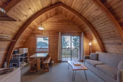 a living room with a couch and a table at Ocean Village Resort in Tofino