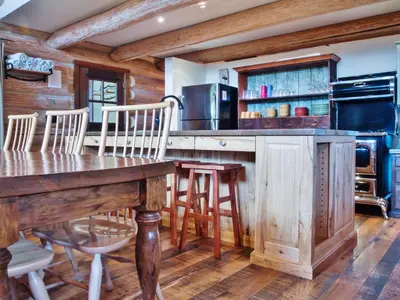 a kitchen with a wooden table and chairs at Snow Creek Cabins by Fernie Lodging Co in Fernie