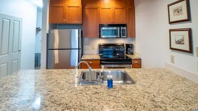 a kitchen with a sink and stainless steel appliances at Timberline Lodges by Fernie Lodging Co in Fernie