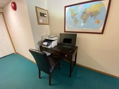 an office with a desk with a computer and a printer at Chalet Continental Motel in Valemount
