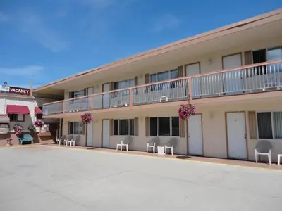 an empty parking lot in front of a hotel at Bella Villa Resort Motel in Osoyoos
