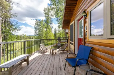 a deck with chairs and a bench on a house at Rocky Mountain Cabins and Home in Golden
