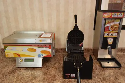 a video game system and a video game controller next to a game machine at Travelodge by Wyndham Lloydminster in Lloydminster