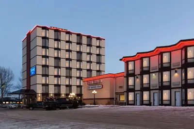 a hotel with a truck parked in front of a building at Travelodge by Wyndham Lloydminster in Lloydminster