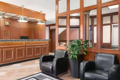 a waiting room with leather chairs and a counter at Travelodge by Wyndham North Battleford in North Battleford
