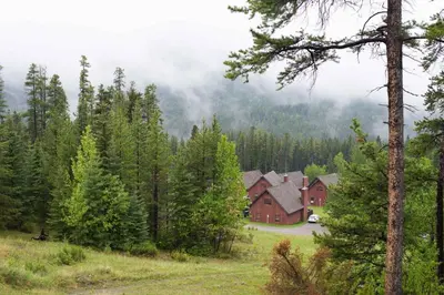 a house in the middle of a forest at Banff Gate Mountain Resort in Canmore
