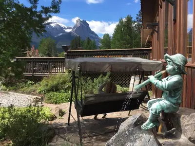 a statue of a girl sitting in a swing at Banff Gate Mountain Resort in Canmore