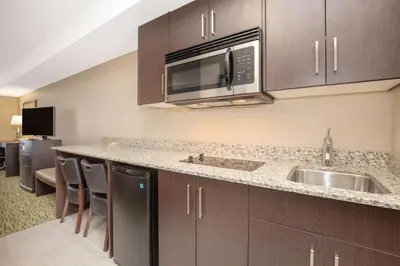 a kitchen with a sink and a microwave at Super 8 by Wyndham Canmore in Canmore