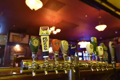 a bar with a row of wine glasses at Tropical Inn - North Battleford in North Battleford