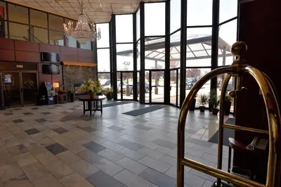 a lobby of a building with a chandelier at Tropical Inn - North Battleford in North Battleford