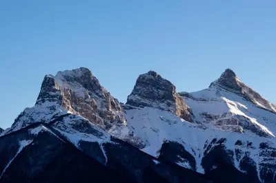 a view of a snow covered mountain at A Bear and Bison Country Inn in Canmore