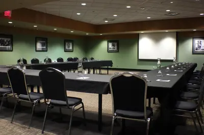 a conference room with tables and chairs and a screen at Stoney Nakoda Resort & Casino in Seebe