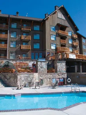 a hotel with a swimming pool in front of a building at Snow Creek Lodge by Fernie Lodging Co in Fernie
