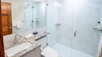 a bathroom with a shower and a sink and a toilet at Snow Creek Lodge by Fernie Lodging Co in Fernie