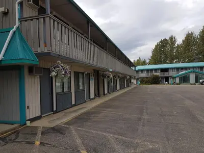 an empty parking lot in front of a building at Alpine Inn in Valemount