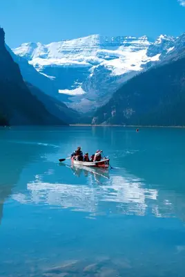 a group of people in a boat on a lake at Paradise Lodge and Bungalows in Lake Louise