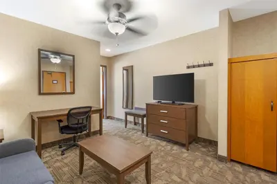 a hotel room with a desk and a television at Best Western Plus Valemount Inn & Suites in Valemount