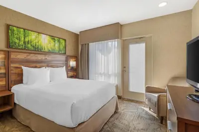 a hotel room with a large bed and a desk at Best Western Plus Valemount Inn & Suites in Valemount