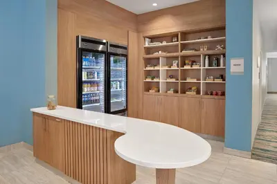 a kitchen with a white table and a refrigerator at Element Edmonton West in Edmonton