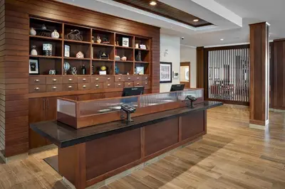 a large lobby with a reception desk in a building at Four Points by Sheraton Edmonton West in Edmonton
