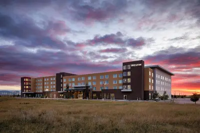 a building with a sign on it in a field at The Westin Calgary Airport in Calgary