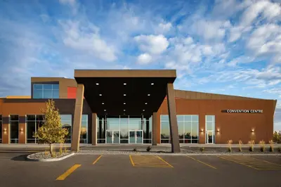 a building with a parking lot in front of it at The Westin Calgary Airport in Calgary