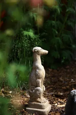 a statue of a dog sitting on the ground at Inn on the Lake - Whitehorse in Marsh Lake
