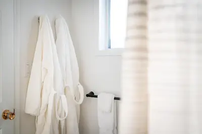 a bathroom with white towels hanging on a wall at Okanagan Lakefront Resort in Penticton