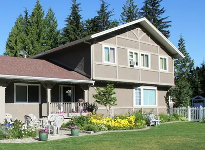 a house with a garden in front of it at Alpenrose Revelstoke Bed & Breakfast in Revelstoke