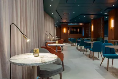 a dining room with tables and chairs and a unintention at Matrix Hotel in Edmonton