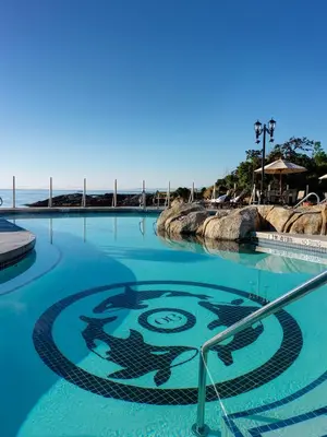a swimming pool with a symbol in the water at Oak Bay Beach Hotel in Victoria