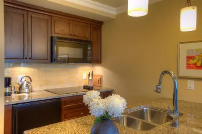 a kitchen with a sink and a counter top at Oak Bay Beach Hotel in Victoria