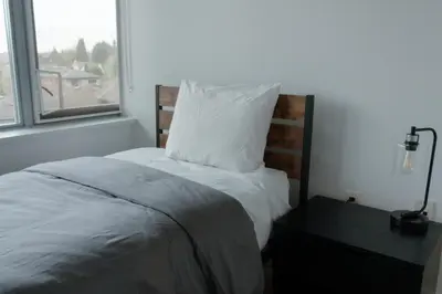 a bedroom with a bed with a pillow and a window at Carey Centre on UBC campus in Vancouver